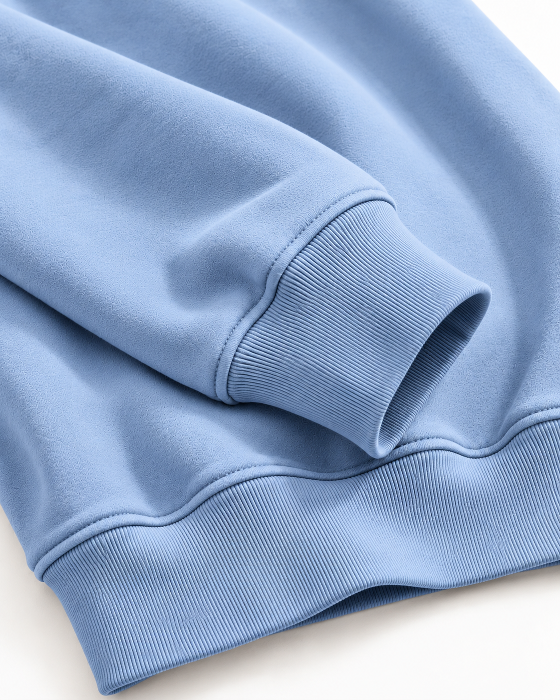 Close-up of the Calcuera Icon Sweatshirt in sky blue showing the ribbed cuff and hem